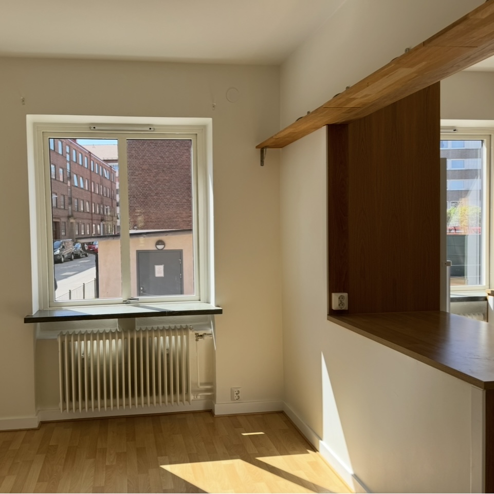 Vit hall med trägolv med passager till kök och vardagsrum  i Halmstad